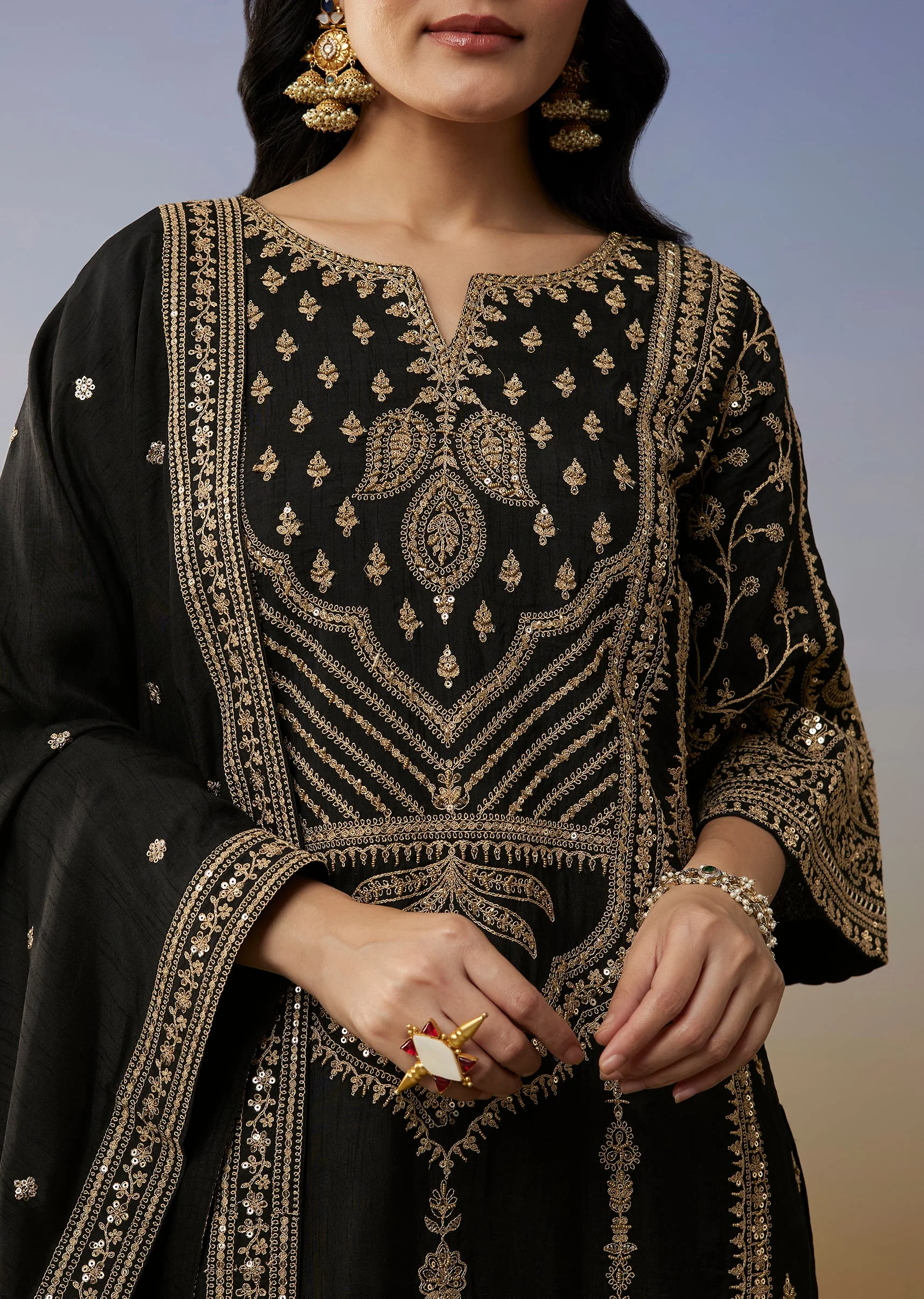 Bold Festive Couple Set – Black Silk Palazzo Suit With Zari Thread And Sequins Work For Her And Black Suiting Jodhpuri Pant Set With Embroidery For Him - Image 2