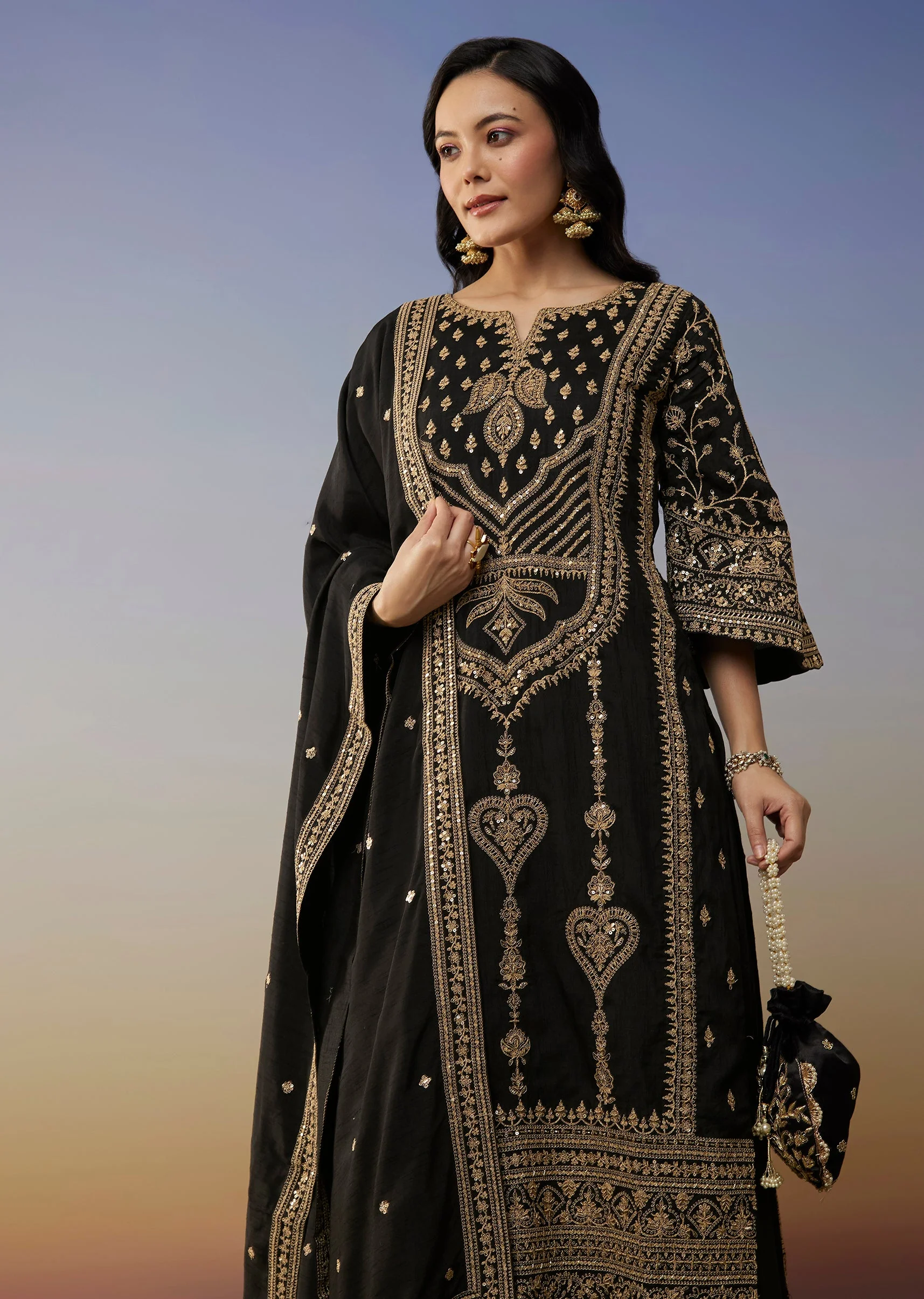 Bold Festive Couple Set – Black Silk Palazzo Suit With Zari Thread And Sequins Work For Her And Black Suiting Jodhpuri Pant Set With Embroidery For Him - Image 4