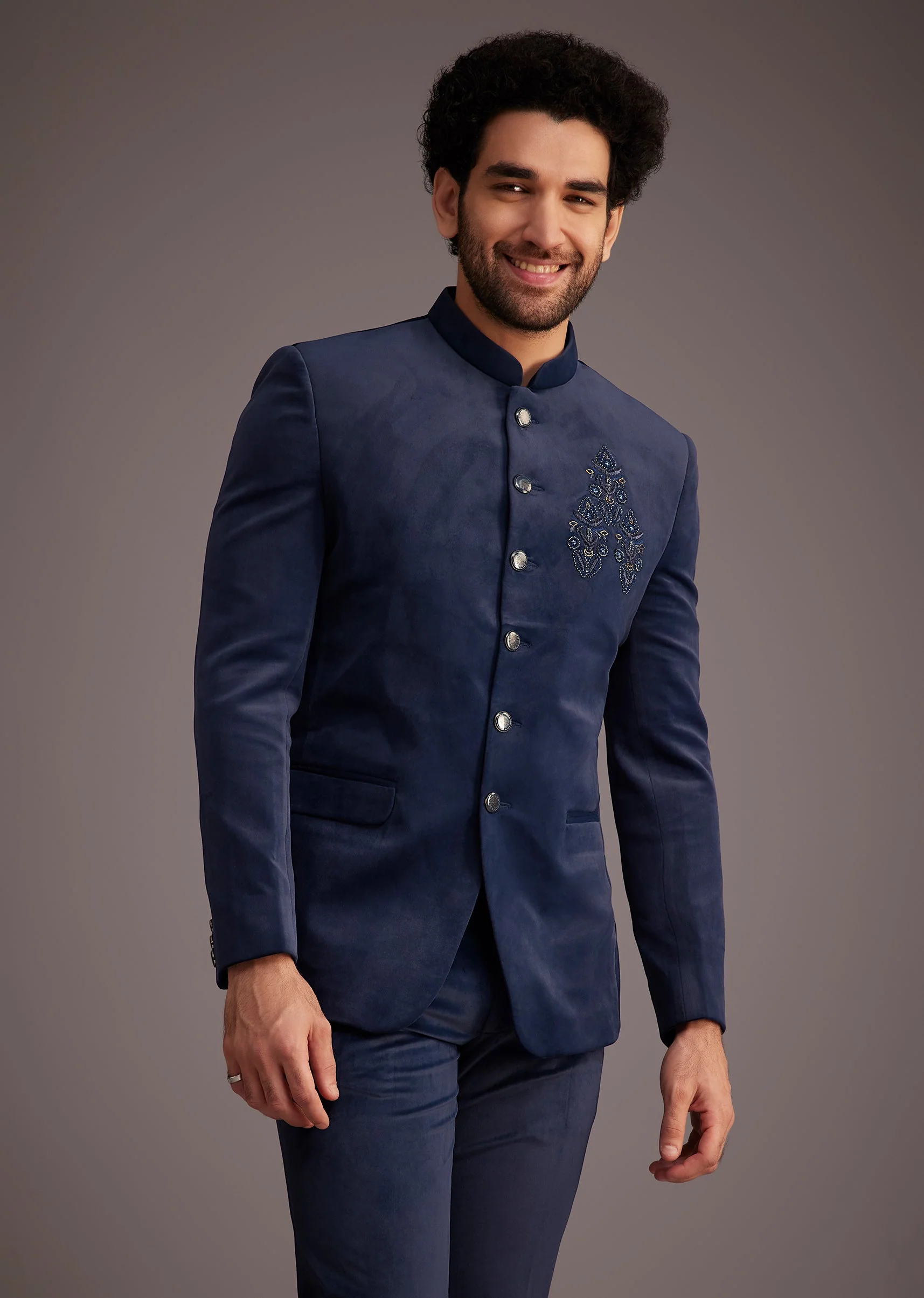 Contemporary Reception Couple Set – Navy Indo-Western Draped Skirt Set with Embroidered Jacket for Her And Blue Embroidered Bandhgala for Him - Image 6