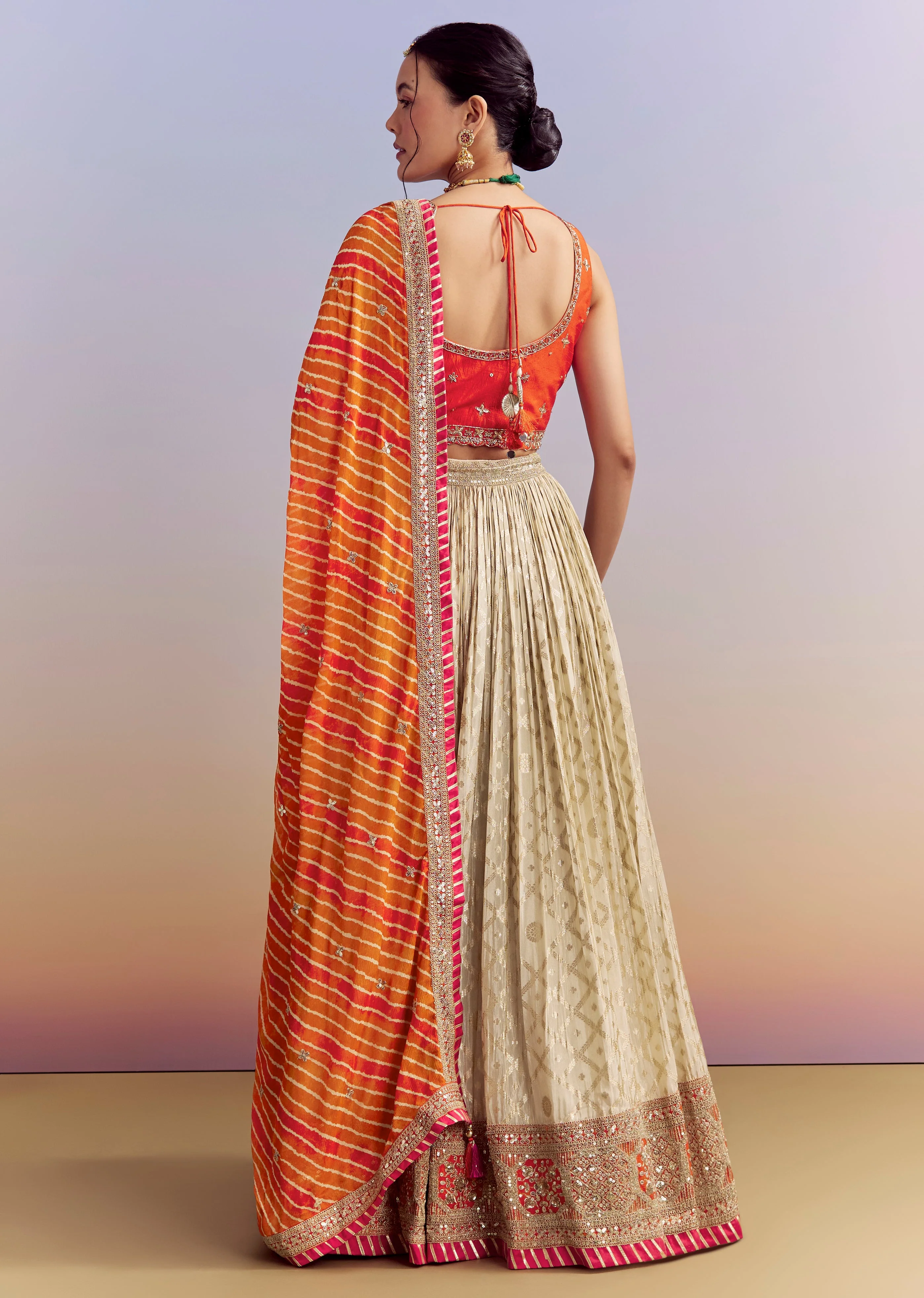 Festive Wedding Couple Set – Orange Brocade Bridesmaid Lehenga with Leheriya Dupatta for Her And Pink Embellished Tissue Kurta Set for Him - Image 5