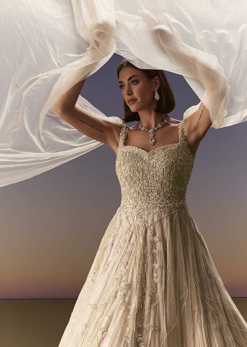Gold Gown With Pleated Panels And Dramatic Cape - Image 5