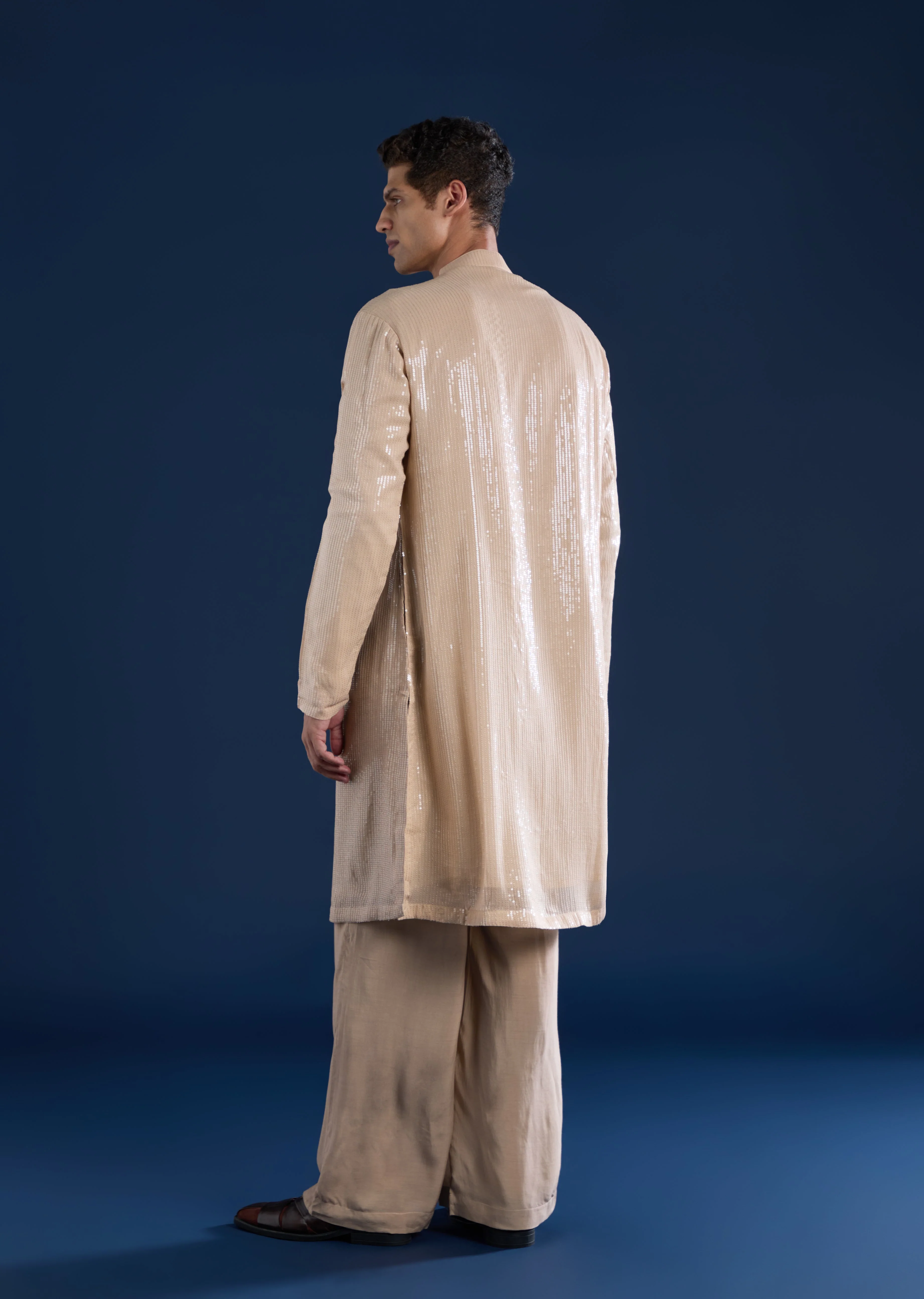 Grand Celebration Couple Set – Gold Ready-Pleated Satin Saree with Stone Detailing for Her And Beige Embroidered Kurta Jacket Set for Him - Image 9