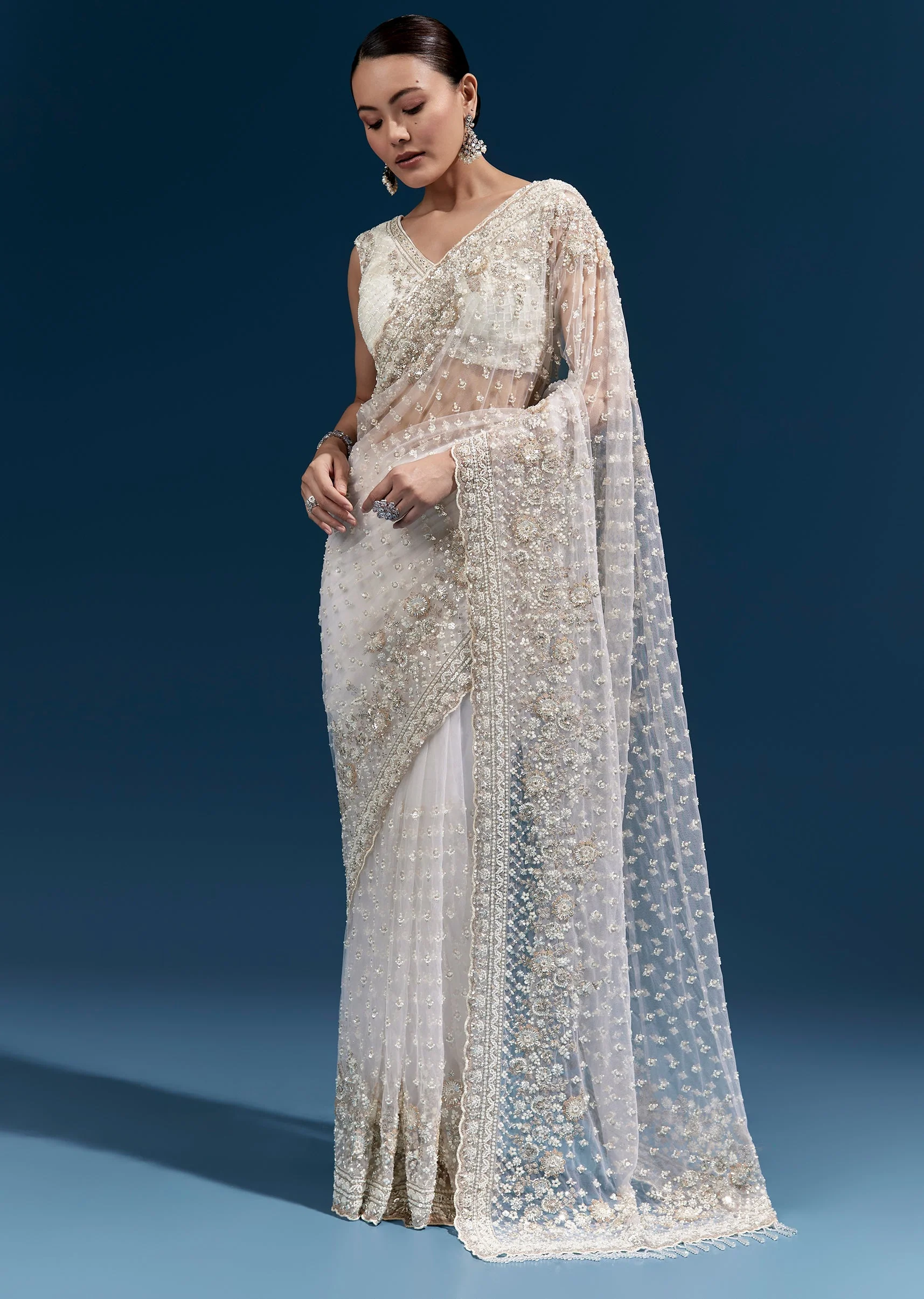 Off White Heavy Embroidered Net Saree With Scalloped Border And Tasselled Pallu