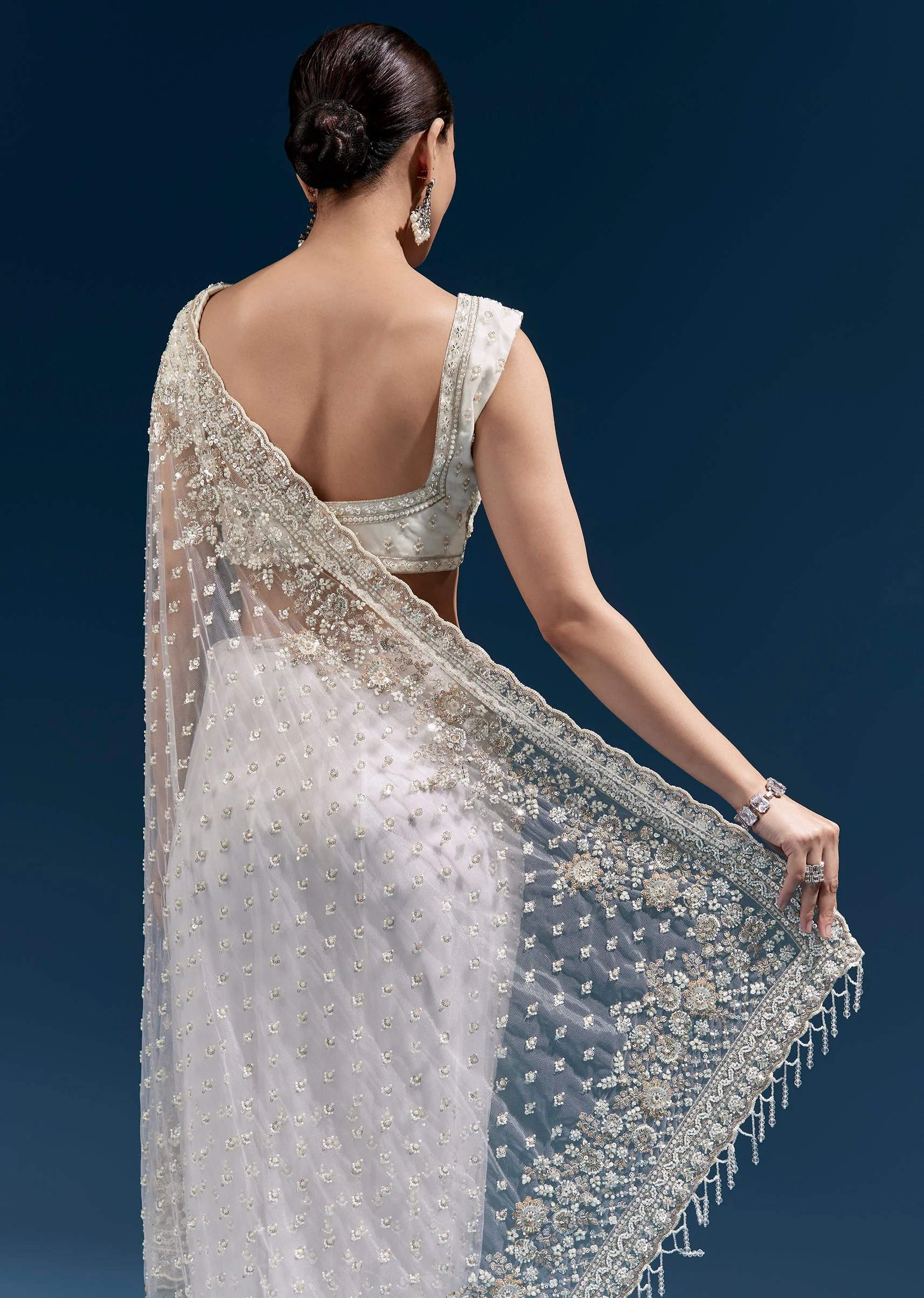 Off White Heavy Embroidered Net Saree With Scalloped Border And Tasselled Pallu - Image 6