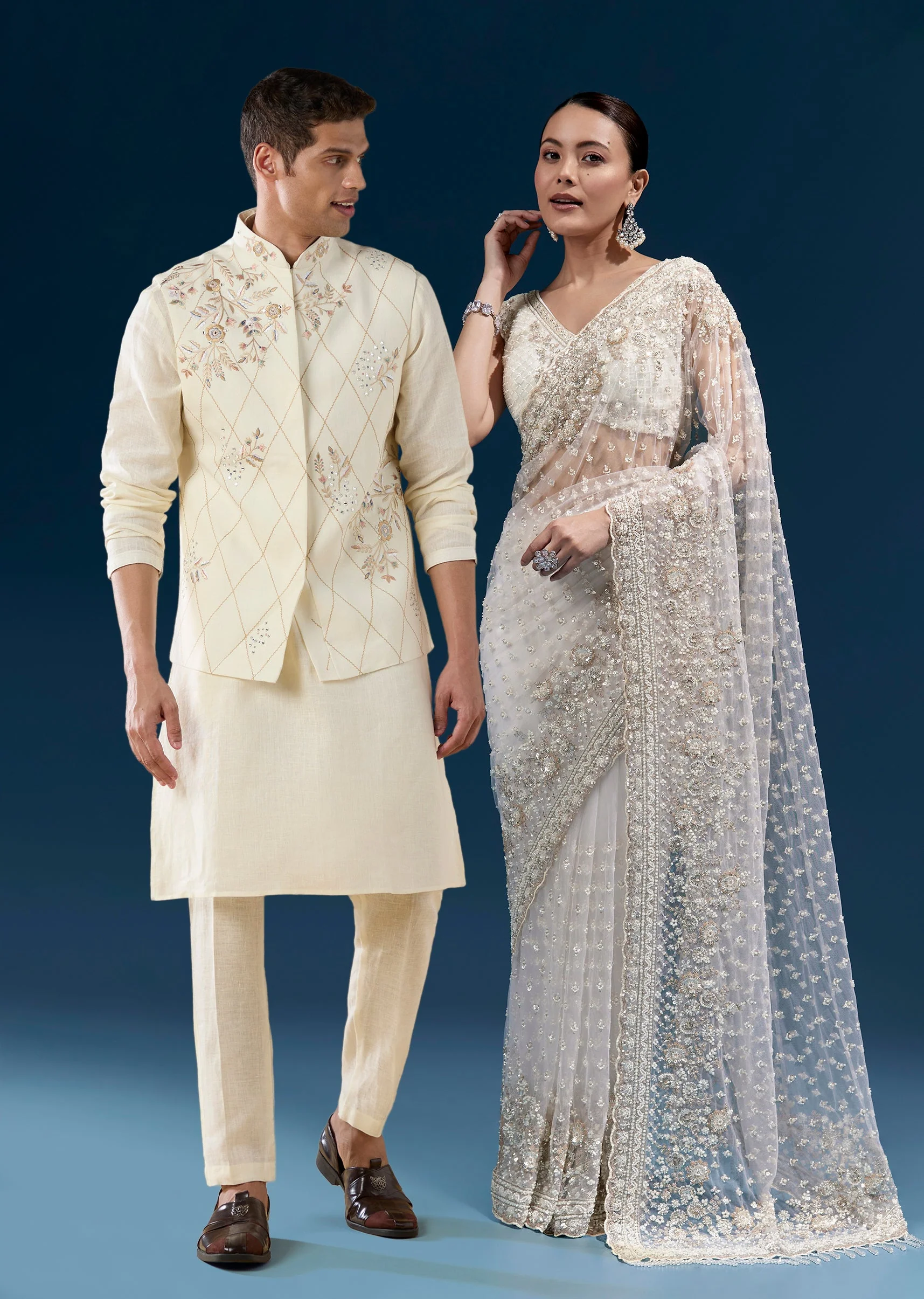 Soft Glow Couple Set – Off-White Heavy Embroidered Net Saree For Her And Cream Art Silk Jacket Kurta Set For Him